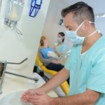 Dentist washes hands